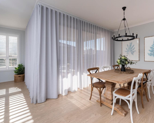 Modern wave-fold curtains hanging on a slim decorative track.