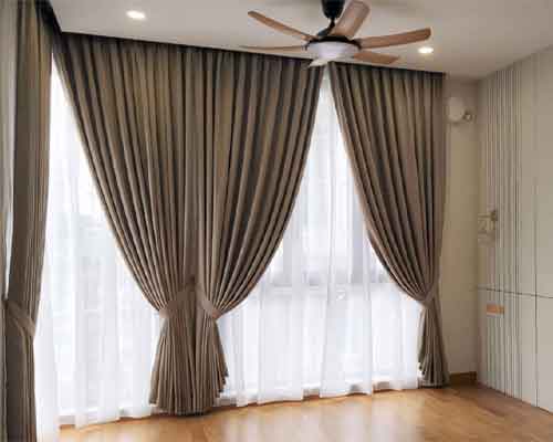 Modern home furniture arrangement featuring stylish window dressings.